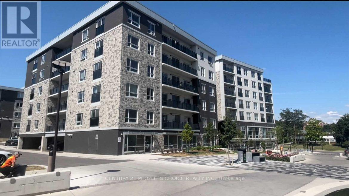 A large, modern apartment building with a clear blue sky in the background.