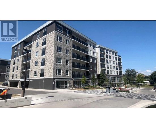 A large, modern apartment building with a clear blue sky in the background.