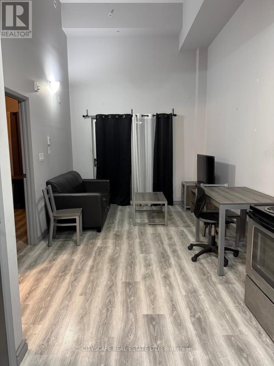 A room with a grey floor and a black curtain.