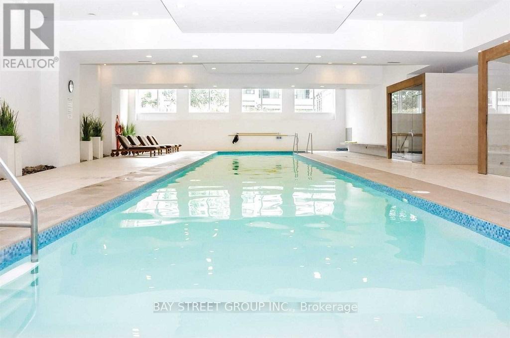 A large indoor swimming pool with a glass bottom.