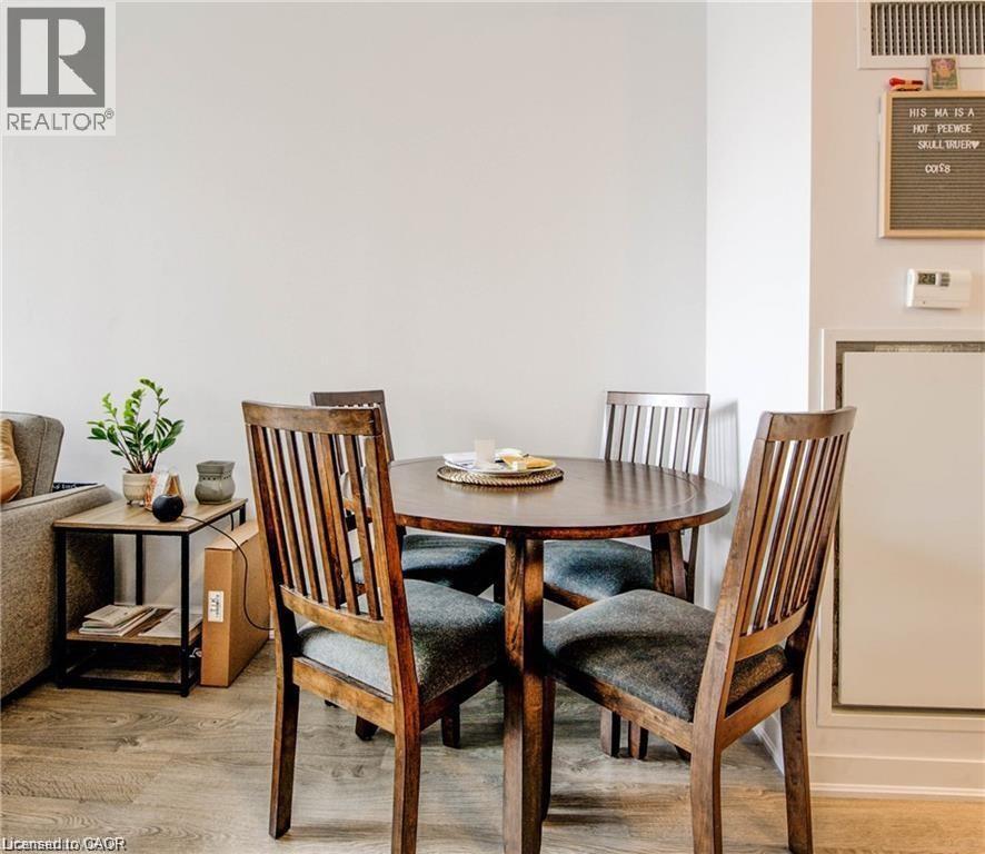 A dining room with a table and chairs.