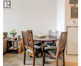 A dining room with a table and chairs.