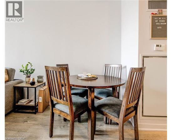 A dining room with a table and chairs.