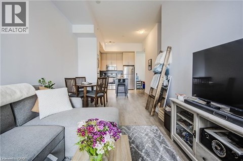 A living room with a grey couch and a wooden coffee table.