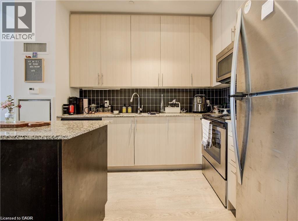 A modern kitchen with a refrigerator on the right.