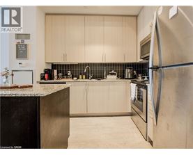 A modern kitchen with a refrigerator on the right.