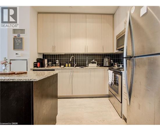 A modern kitchen with a refrigerator on the right.