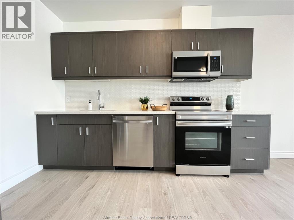 A modern kitchen with a stainless steel dishwasher and oven.