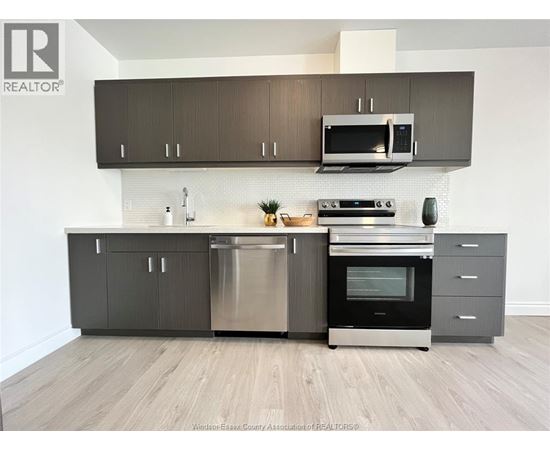 A modern kitchen with a stainless steel dishwasher and oven.
