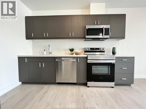 A modern kitchen with a stainless steel dishwasher and oven.