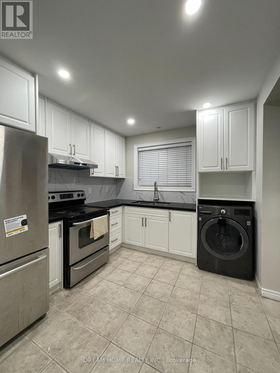 A kitchen with white cabinets and black appliances.