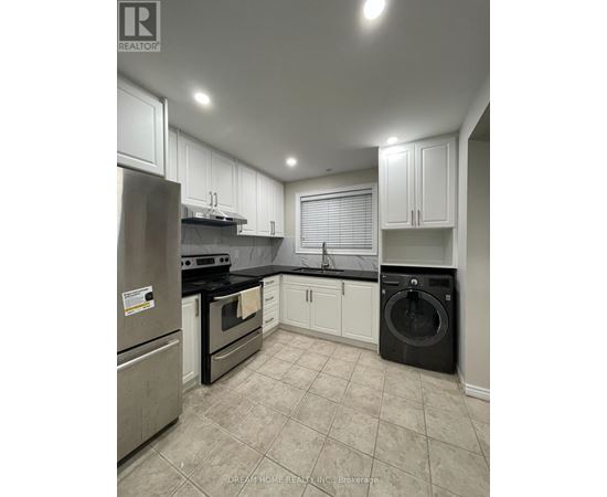 A kitchen with white cabinets and black appliances.