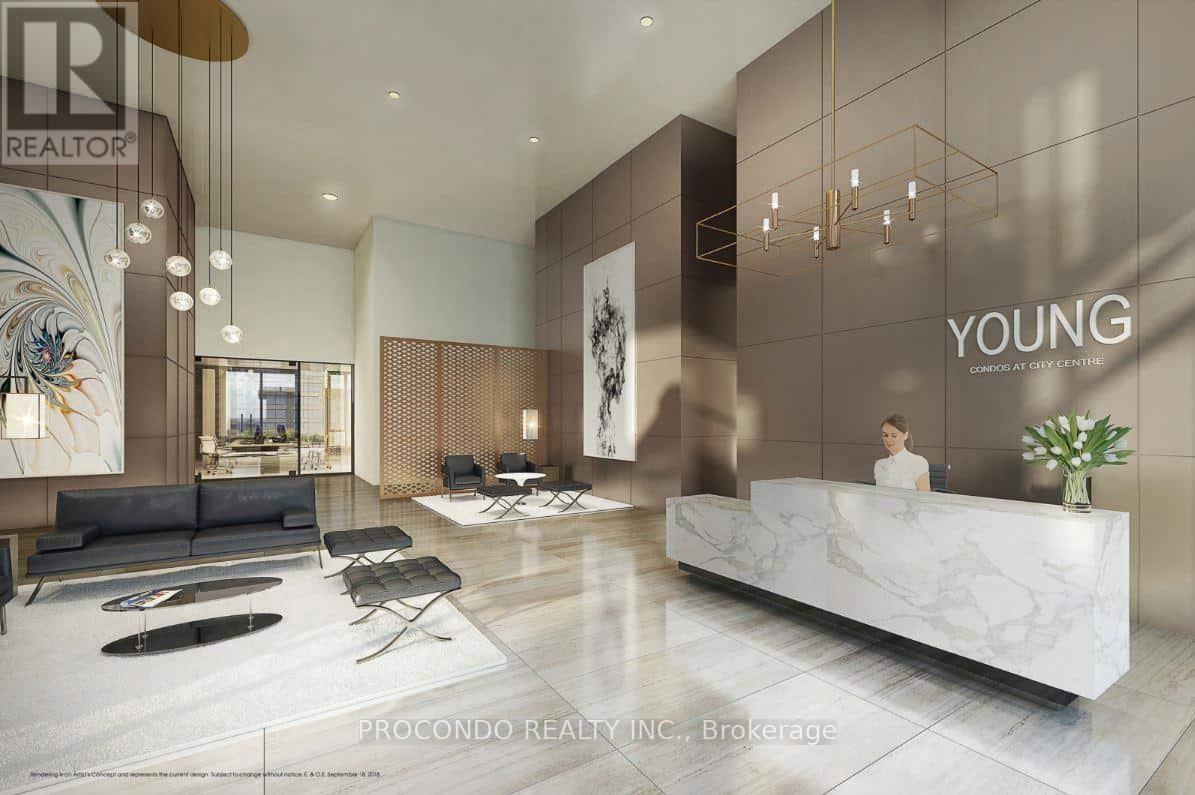 A reception area with a woman standing behind the desk.