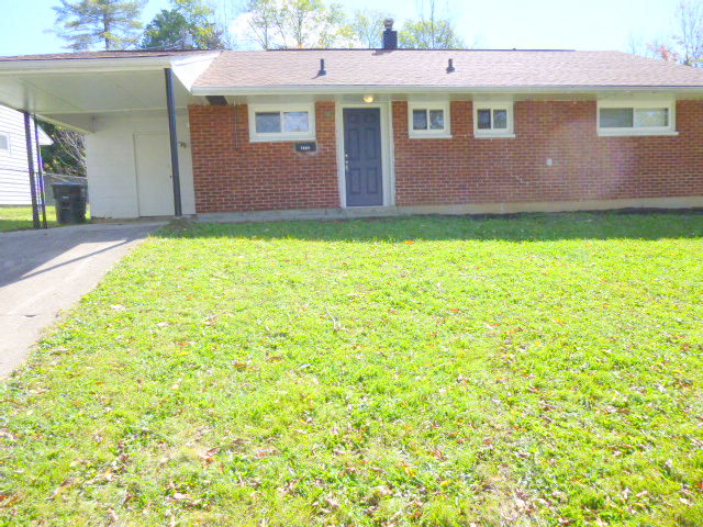 a brick house with a lawn in front of it