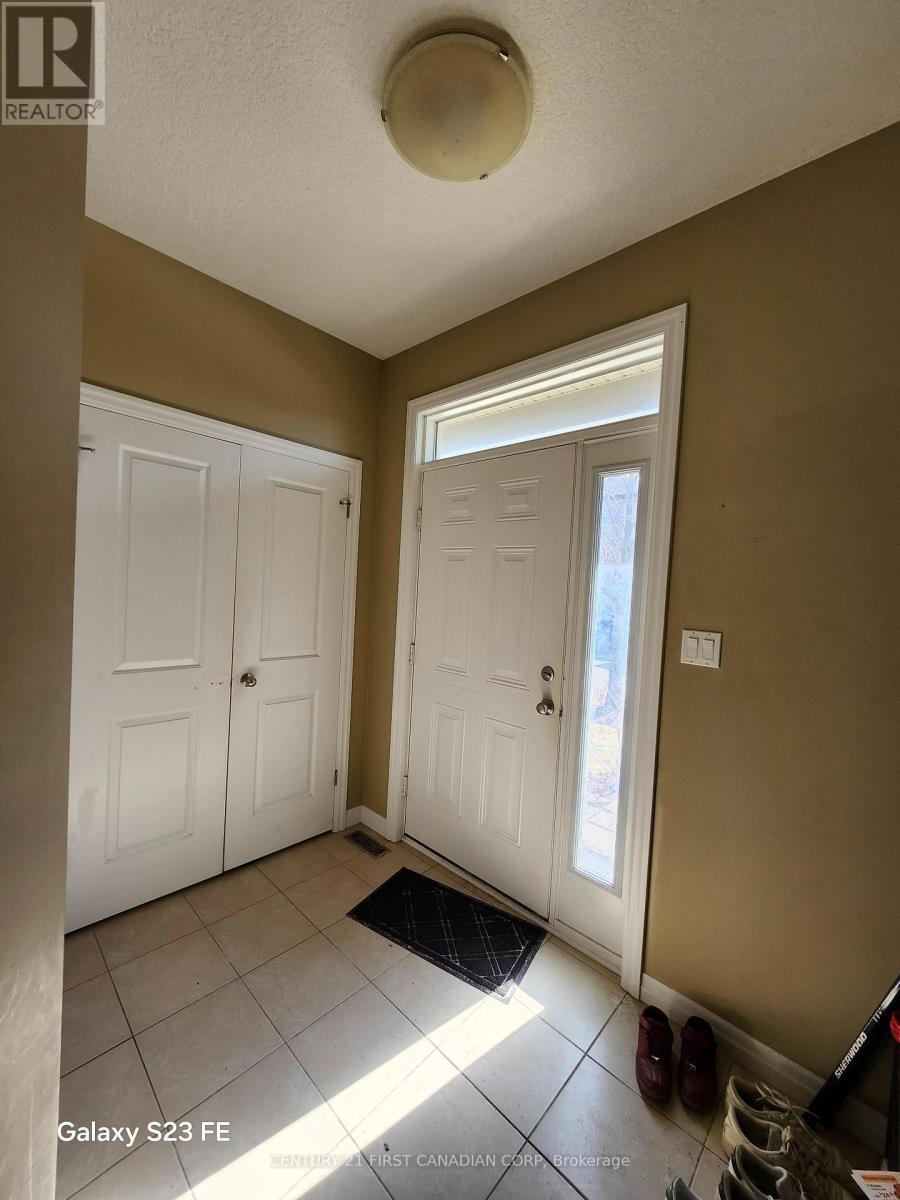 A hallway with two doors and a mat on the floor.