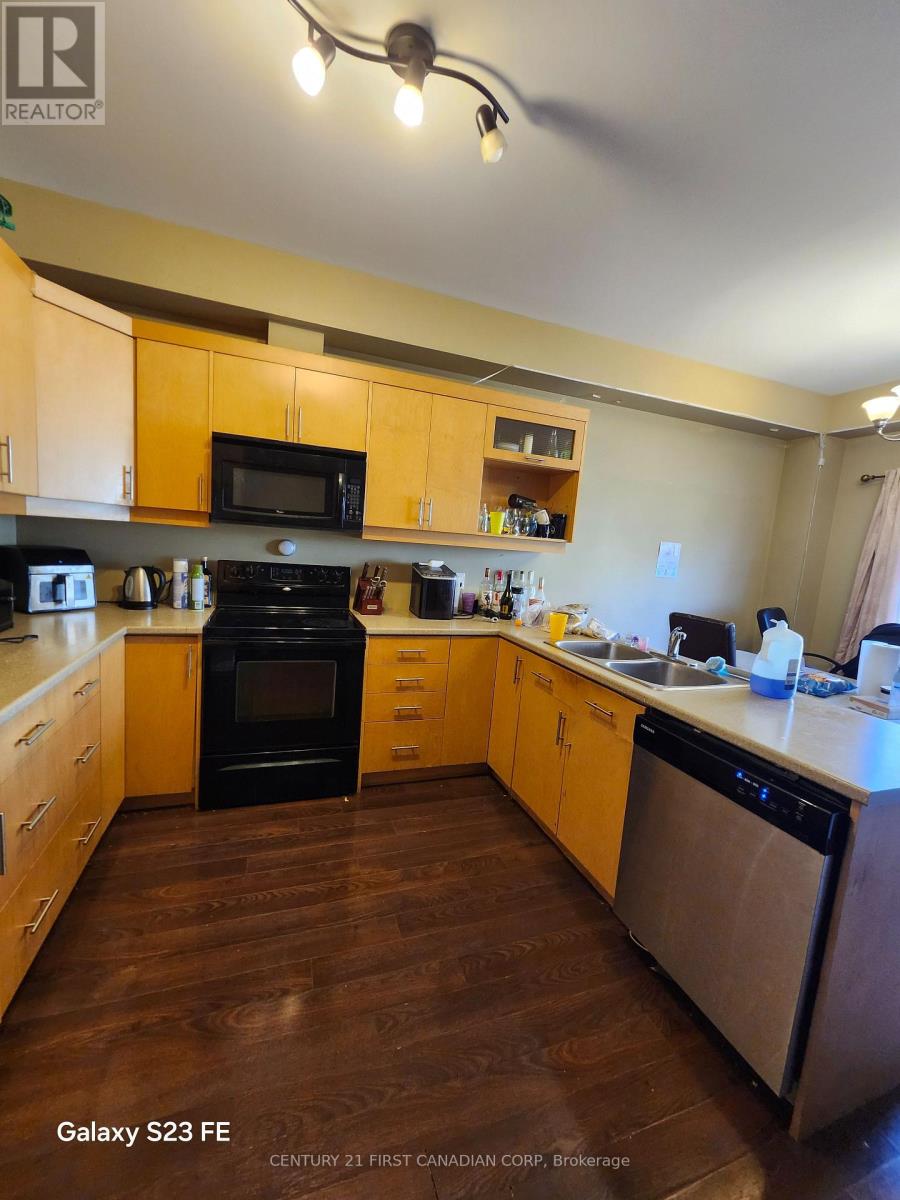 A kitchen with wooden cabinets and a black oven.