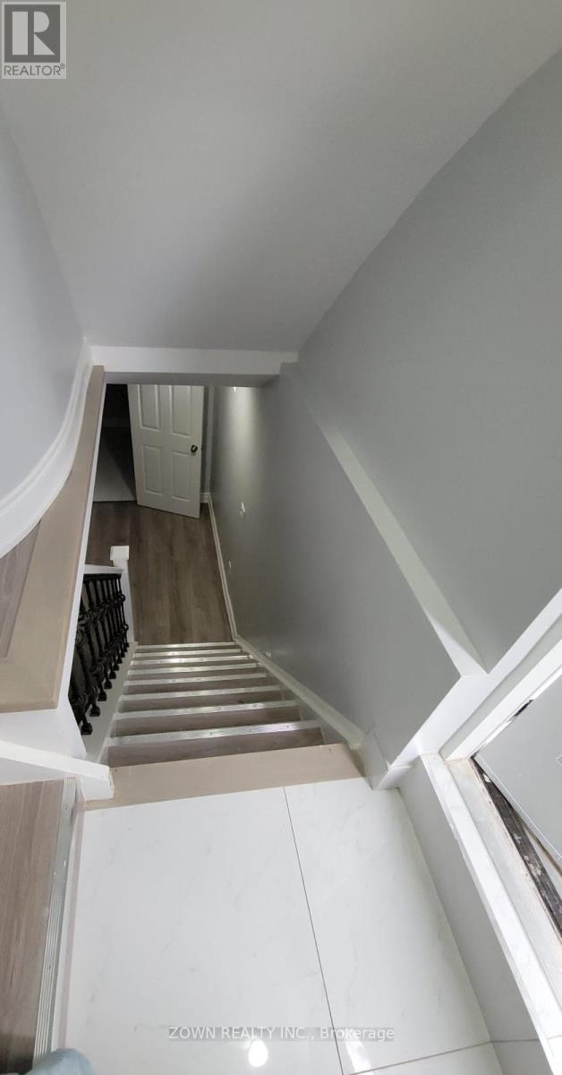 A staircase with a white railing and a white door at the top.