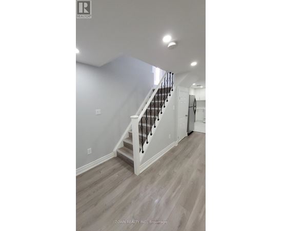 A staircase with a white railing and wooden steps.