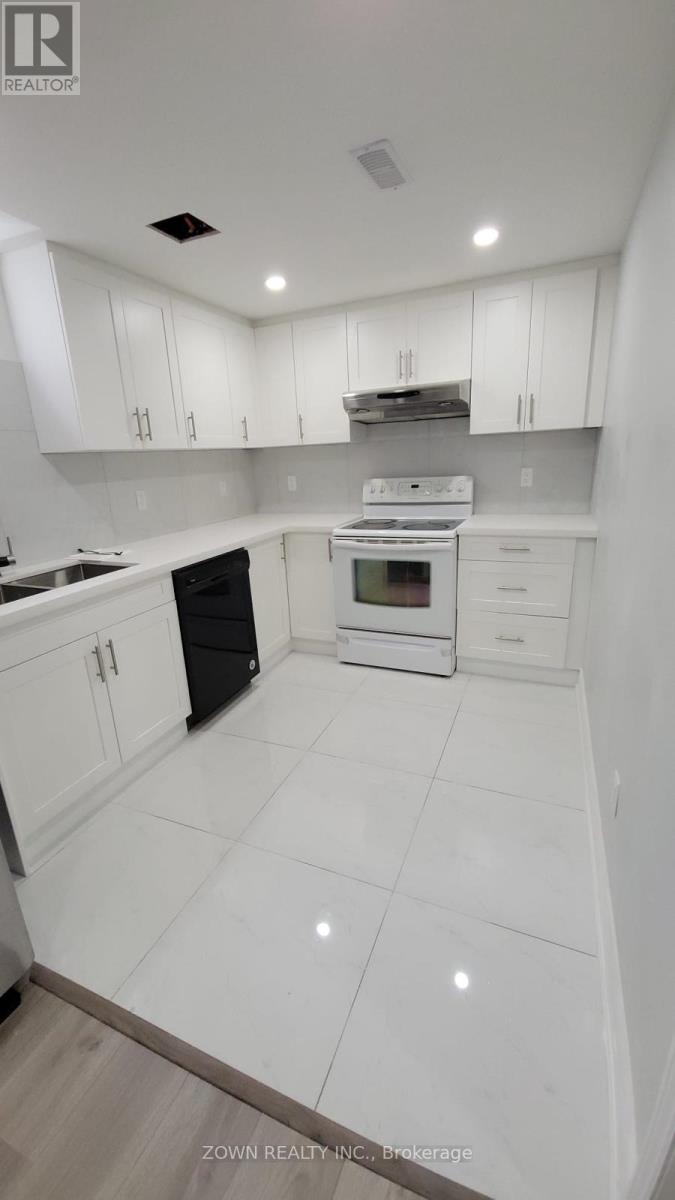 A white kitchen with a black oven and white cabinets.