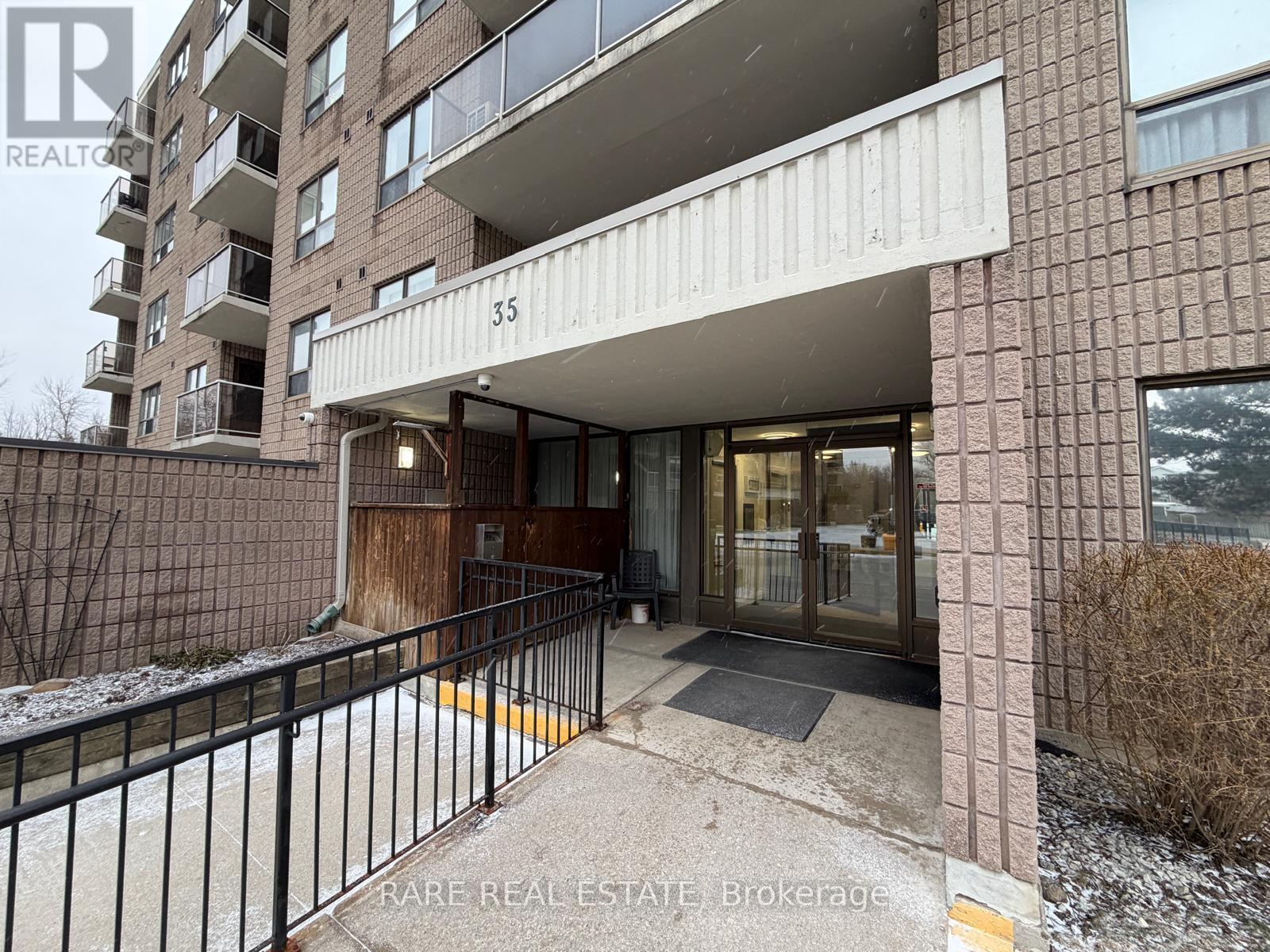 The entrance to a building with a sign that reads "RARE REAL ESTATE Brokerage".