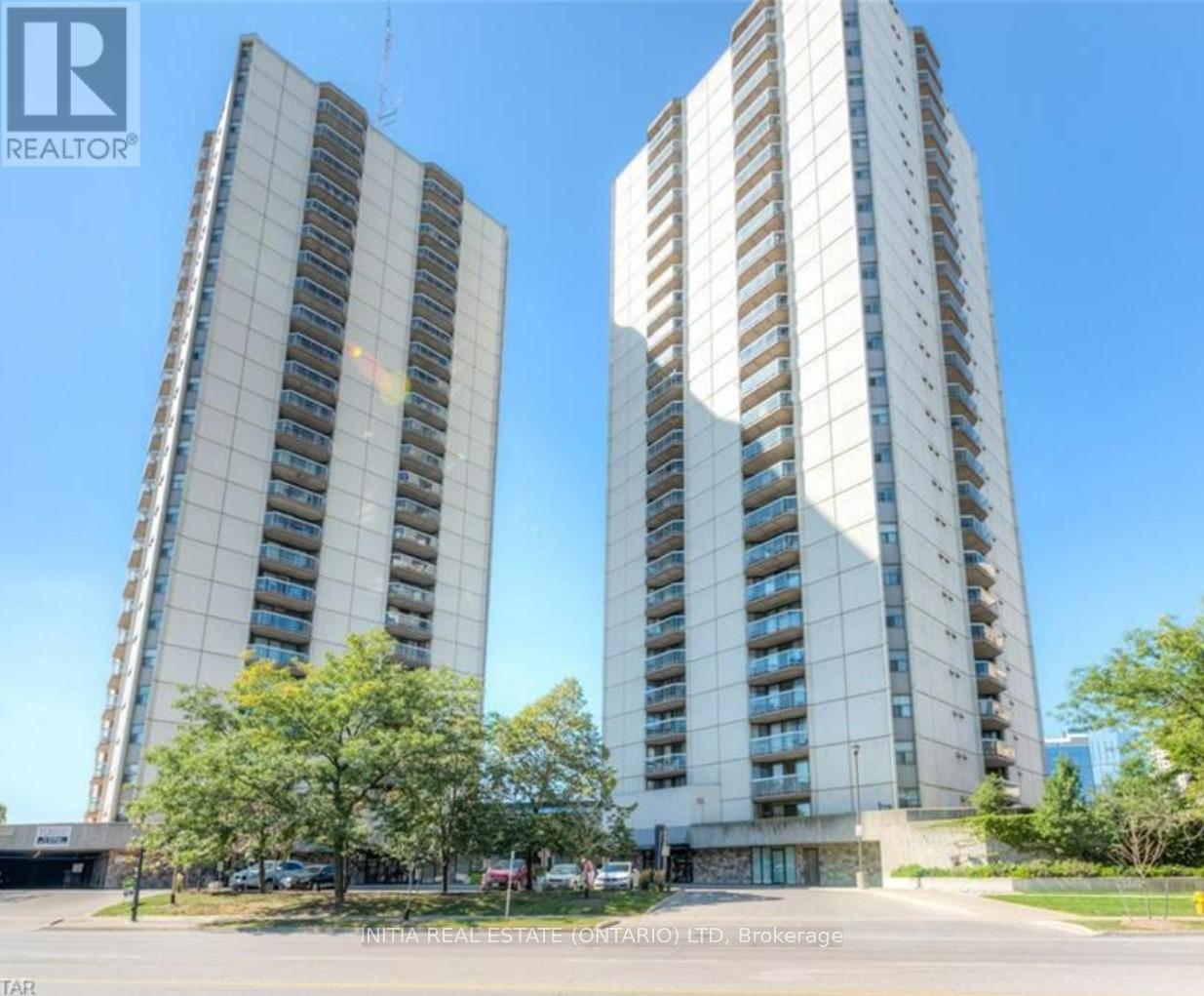 Two tall buildings with balconies are shown in the image.