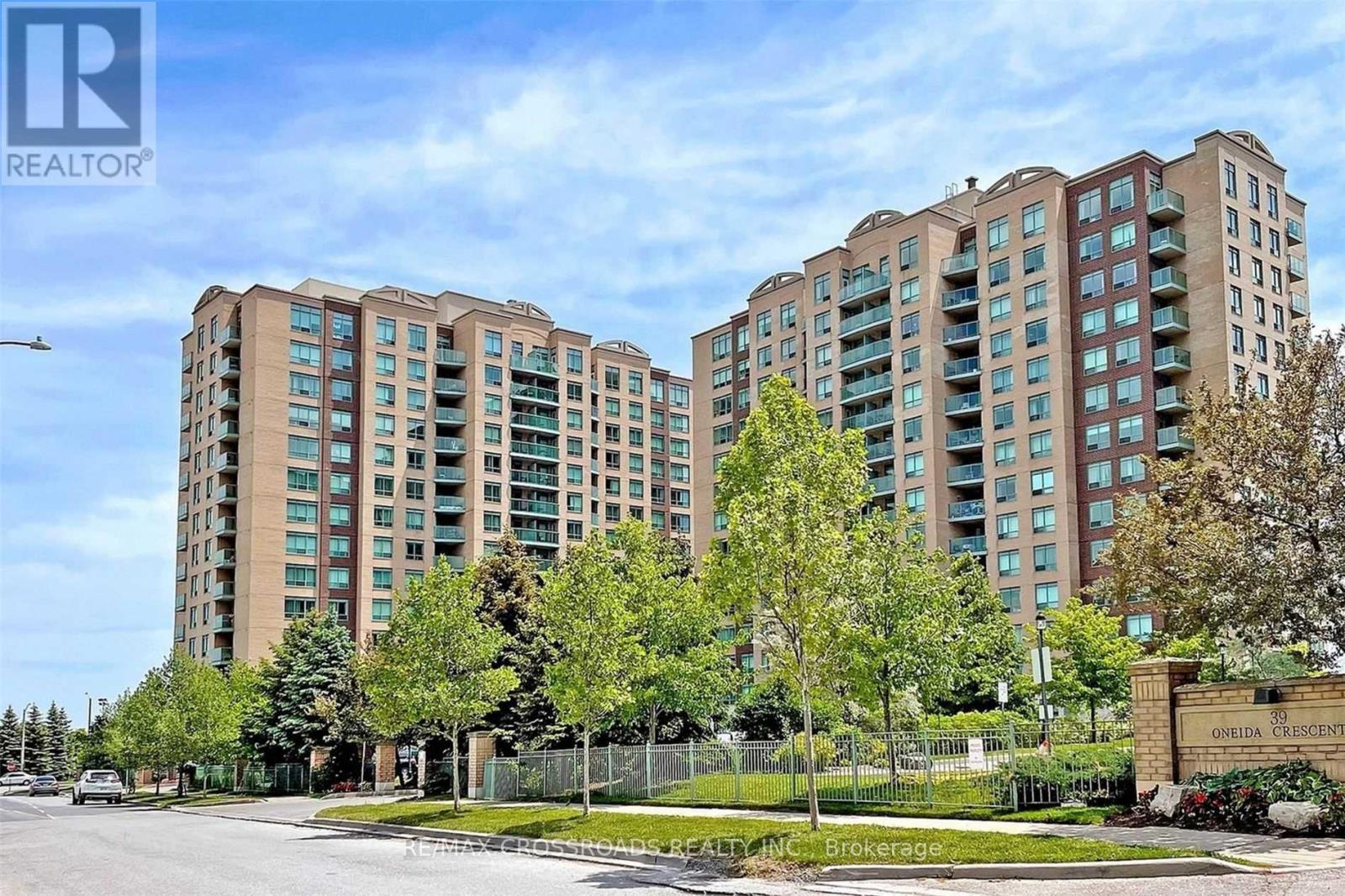 A large apartment complex with a sign that says "Cedar Grove" in front of it.