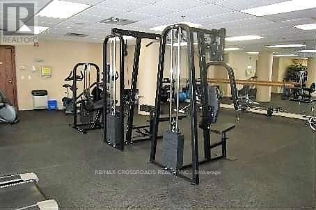 A gym with a variety of equipment including treadmills, weights, and exercise machines.