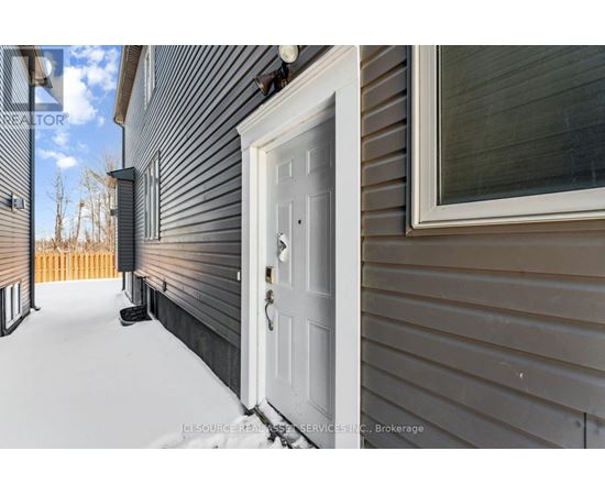 A white door is on the left side of a house.