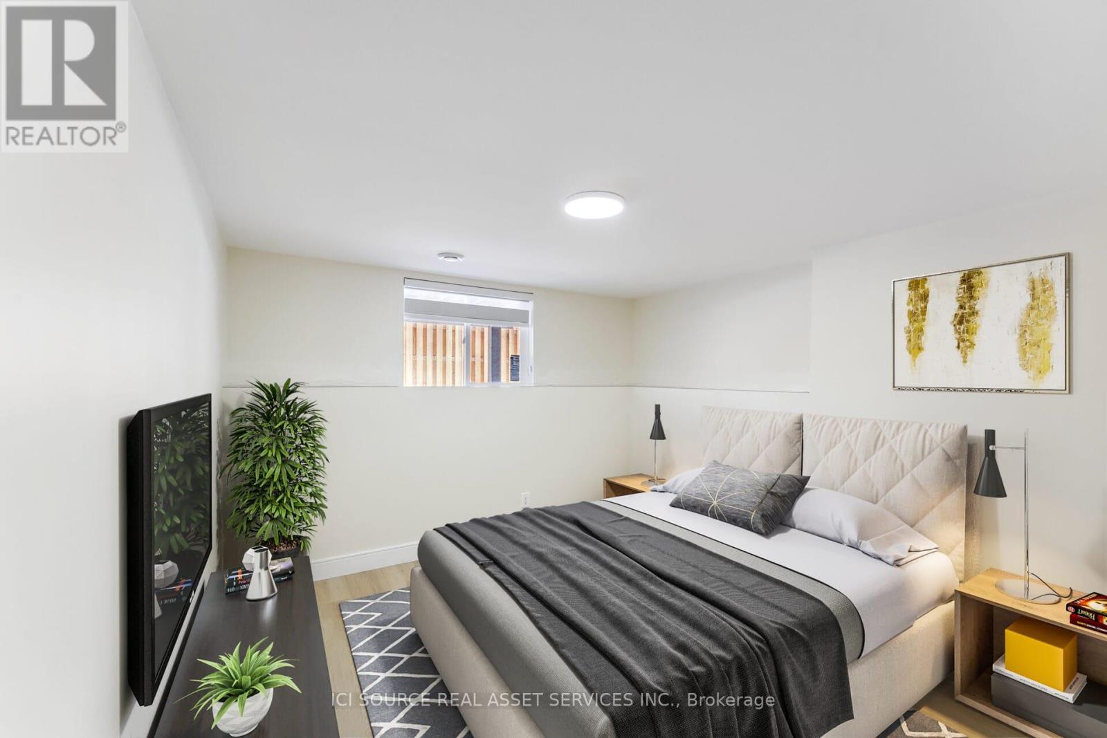 A bedroom with a large bed and a flat screen TV.