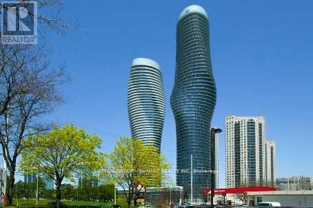Two tall buildings with curved sides stand next to each other.