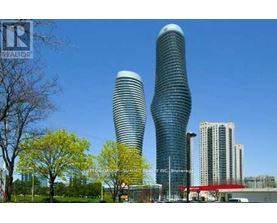 Two tall buildings with curved sides stand next to each other.