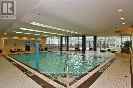 A large indoor swimming pool with a blue pole in the middle.