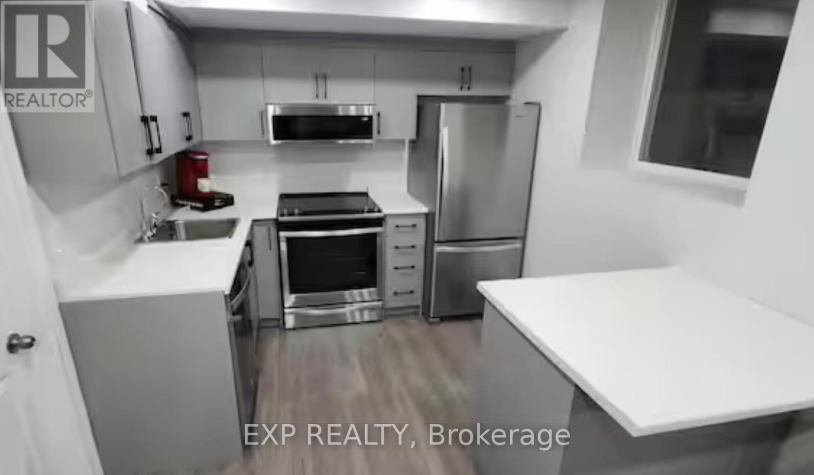 A kitchen with white cabinets and stainless steel appliances.