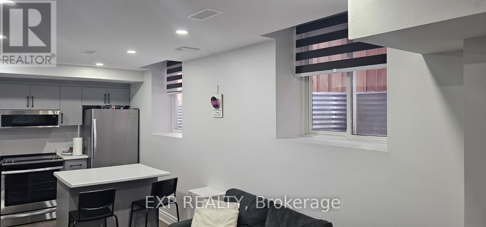 A modern kitchen with a dining table and chairs.