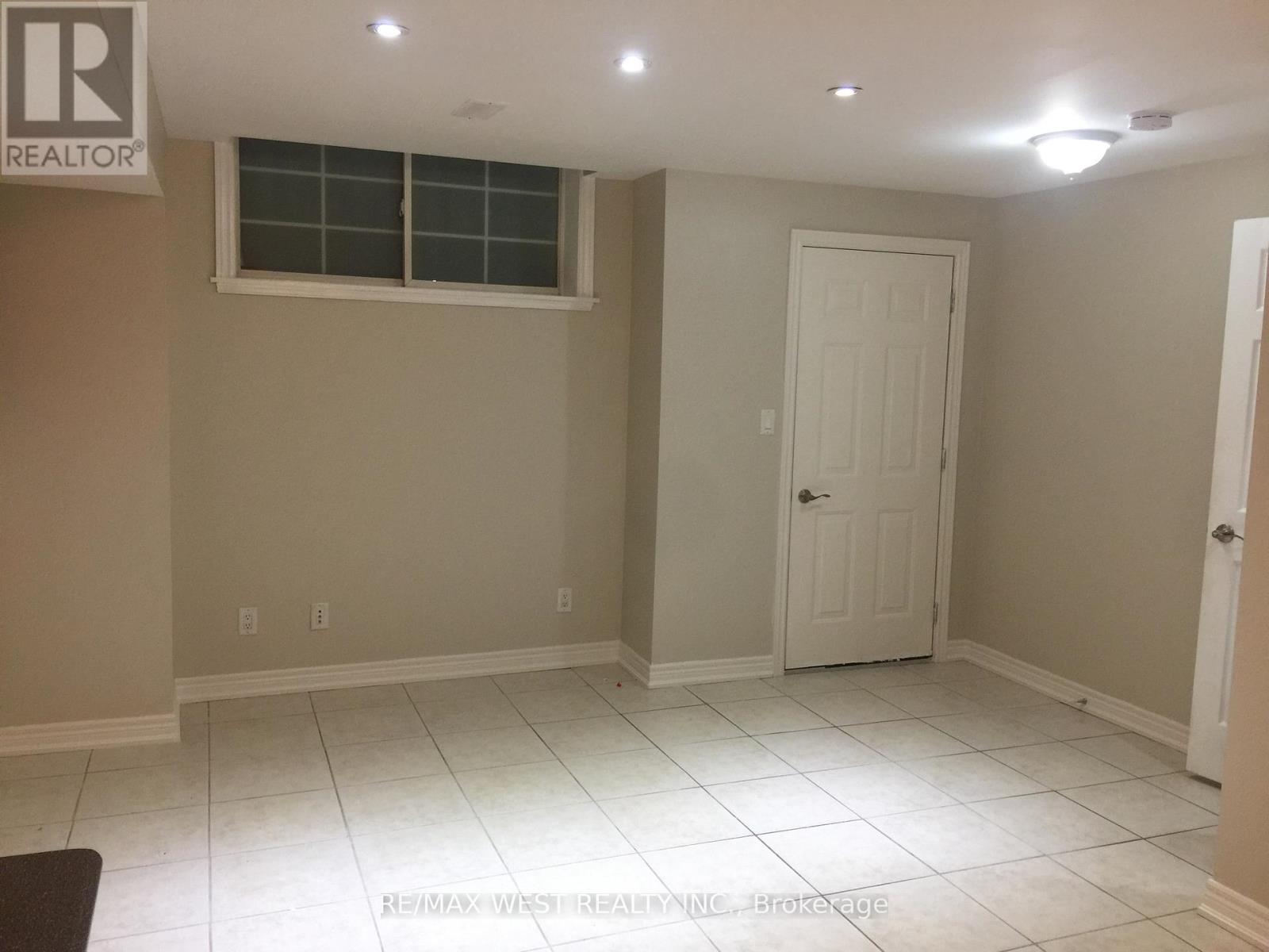 A room with a white door and a window.