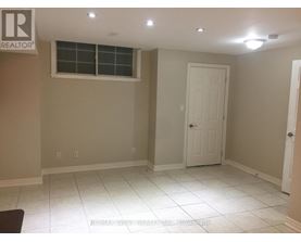 A room with a white door and a window.