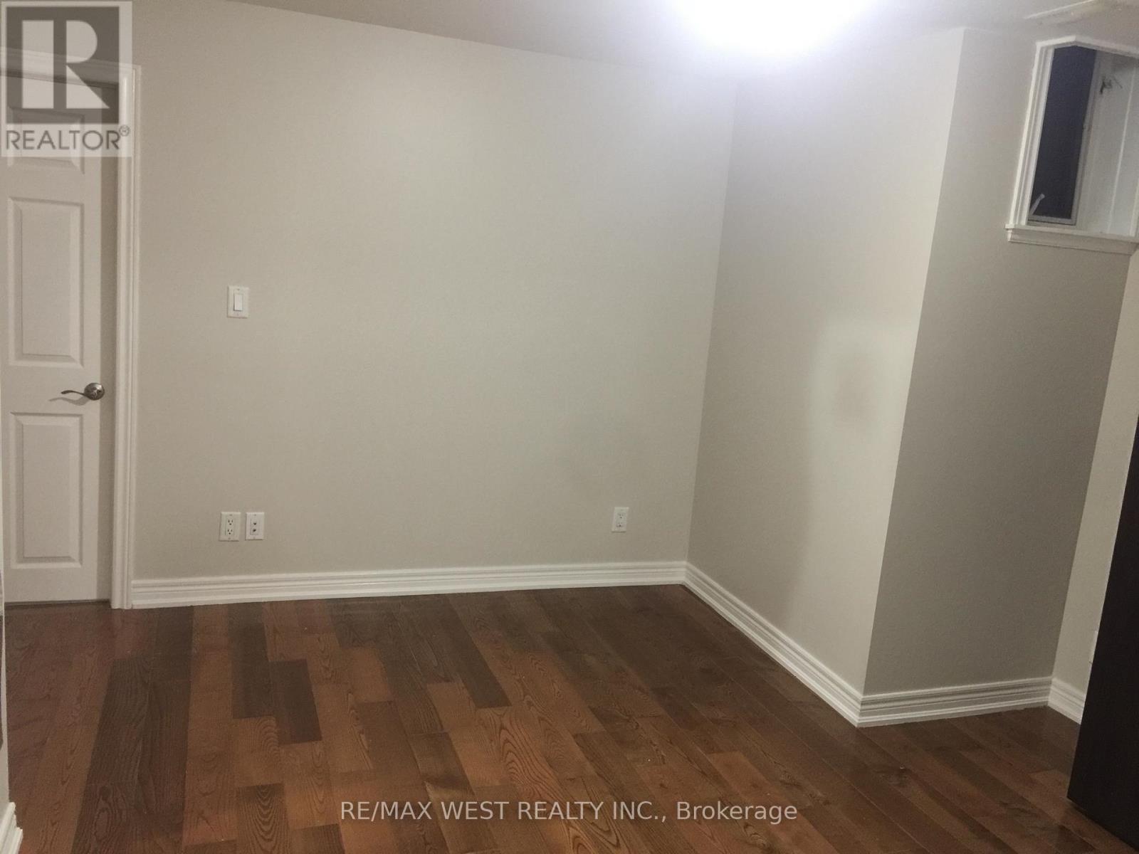 A room with a wooden floor and a door.