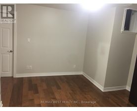 A room with a wooden floor and a door.