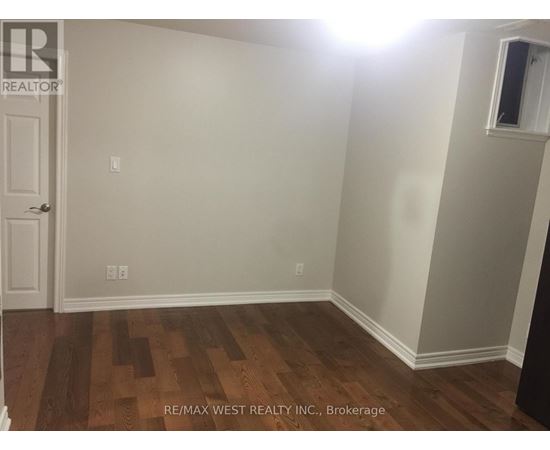 A room with a wooden floor and a door.