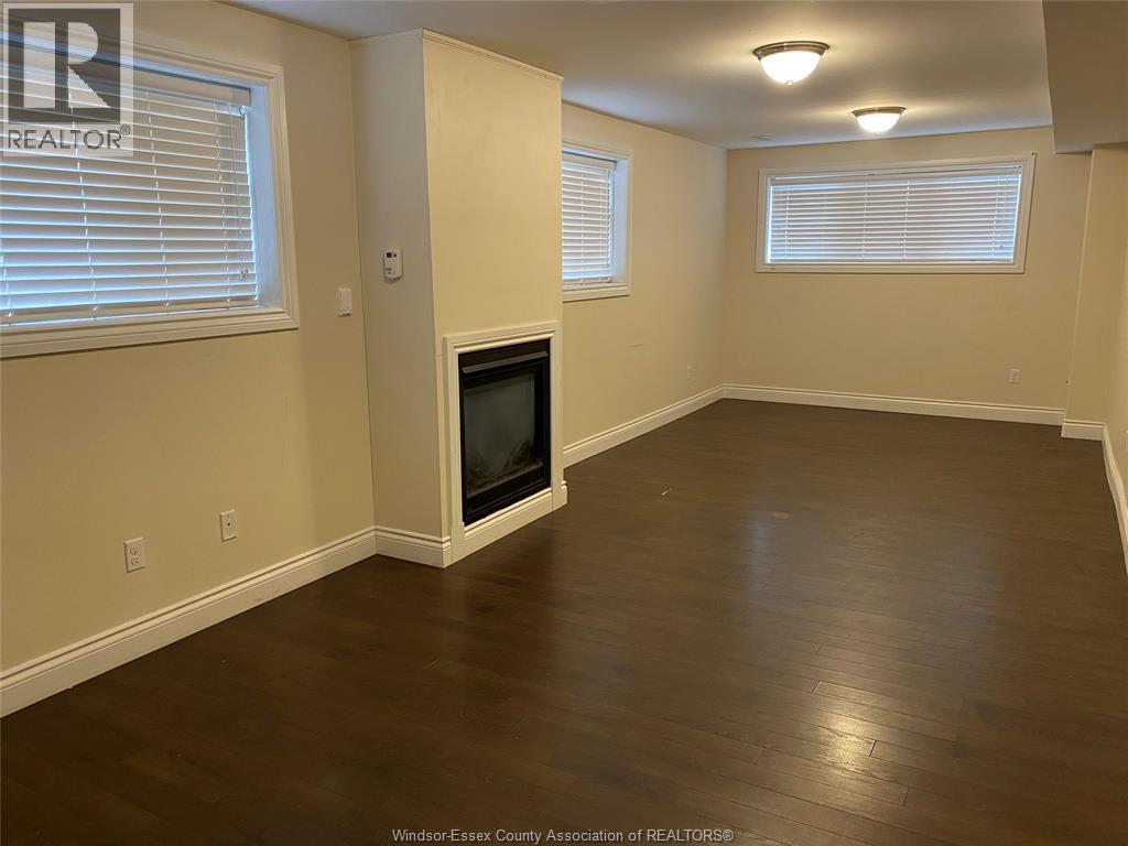 A room with a television and two windows.