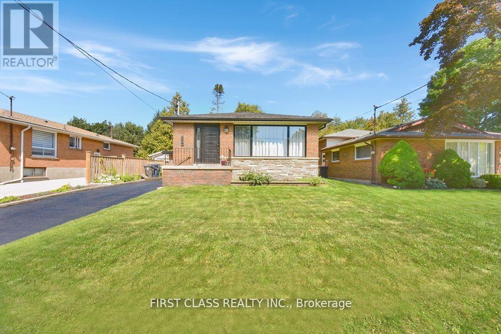 A real estate photo of a house with a lawn in front.