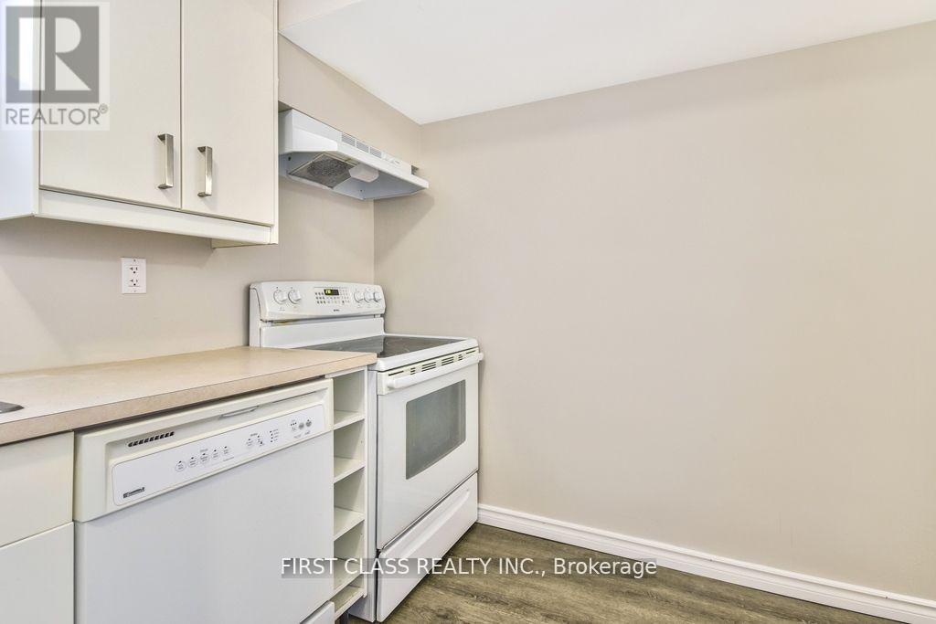 A kitchen with white appliances and cabinets.