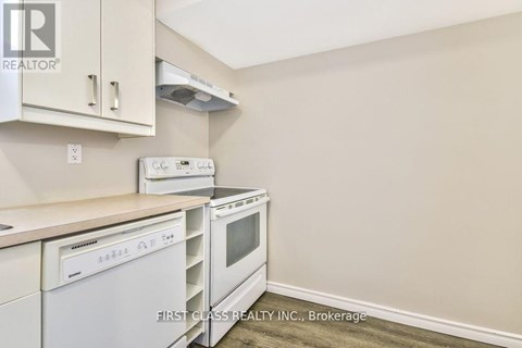 A kitchen with white appliances and cabinets.