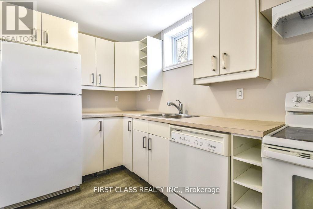 A kitchen with white appliances and cabinets.