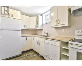 A kitchen with white appliances and cabinets.