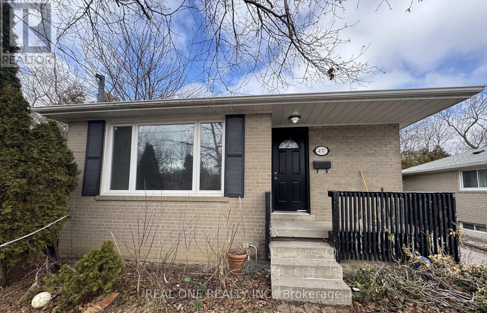 A house with a black front door and a small porch.
