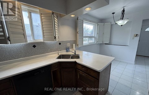 A kitchen with a sink and a window.