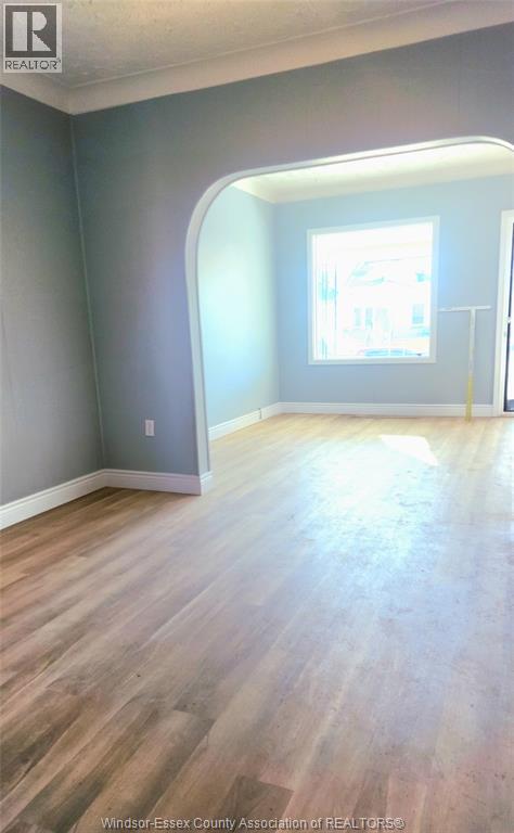A room with wooden flooring and a window.