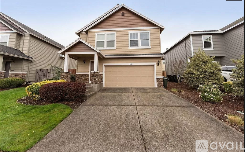 A house with a brown garage door is for sale.