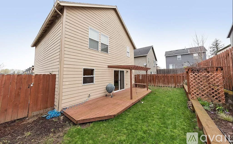 A house with a brown fence and a deck.